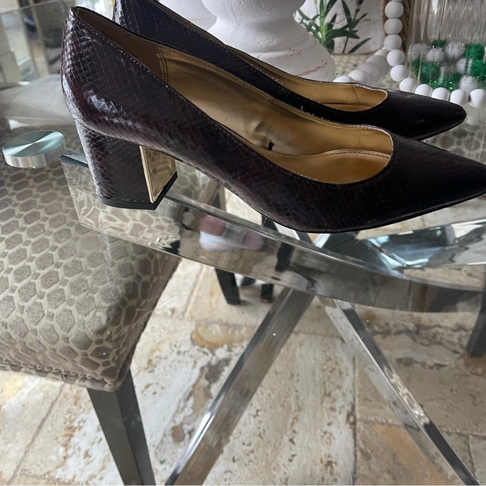 Vintage but hardly worn maroon snakeskin shoes.Gold accents on heels .Smoke free